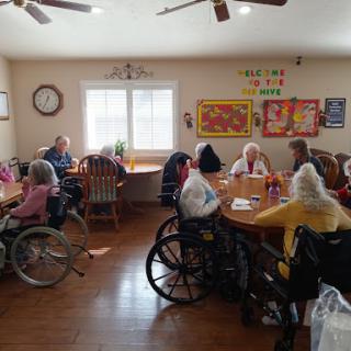 Residents engaging in activities in a communal space at a nursing home.