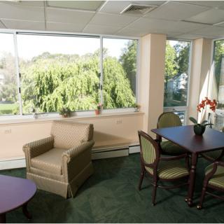 A cozy living room with large windows and comfortable seating.