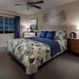A cozy and well-decorated bedroom with modern furnishings and soft lighting.