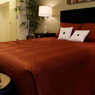 A cozy bedroom with a warm color scheme and modern decor.