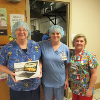 Three dedicated healthcare professionals posing together, celebrating a special moment.