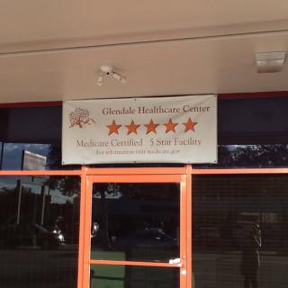 A storefront with a business sign for Chindale Health Care Service displaying a five-star rating.