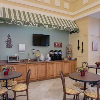 A cozy indoor cafe with a self-service coffee station and seating area.