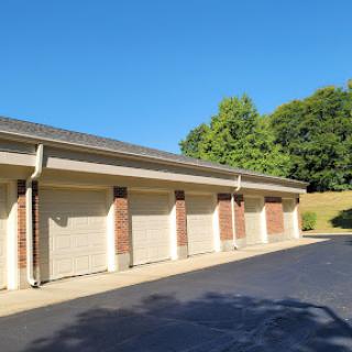 A row of storage units with a clear blue sky overhead.