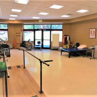 A spacious and well-equipped physical therapy room designed for rehabilitation exercises.