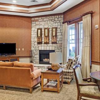 A cozy living room featuring a fireplace, television, and comfortable seating.