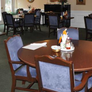 A dining area with neatly arranged tables and chairs, ready for guests.