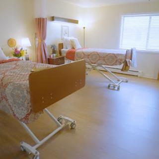 A tranquil hospital room featuring two adjustable patient beds.