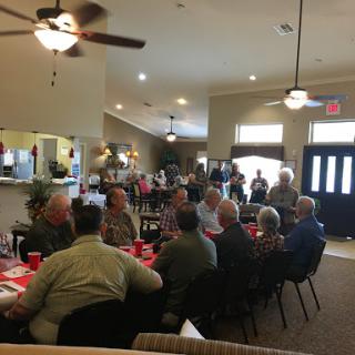 A lively gathering of people enjoying a meal together.