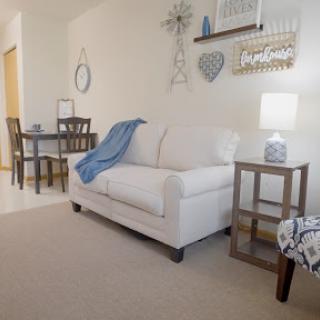 A cozy living room setup featuring a comfortable sofa, decorative elements, and warm lighting.