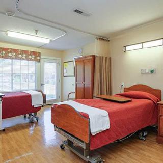 A clean and organized hospital room with two patient beds.