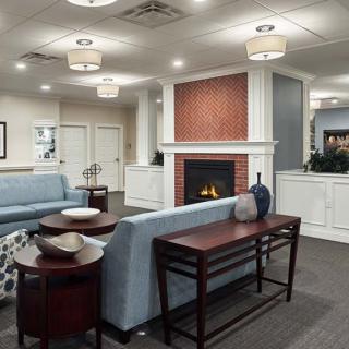 A cozy and modern living room with a fireplace and comfortable seating.