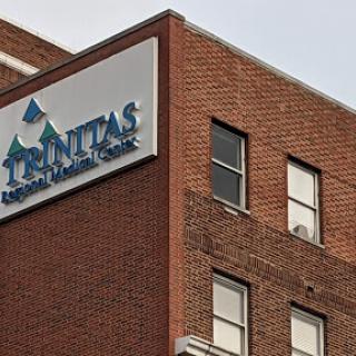 A close-up view of the Prominently displayed sign on a brick building, indicating a healthcare facility.