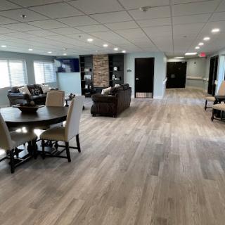 A spacious and modern living area featuring a dining set and comfortable seating.