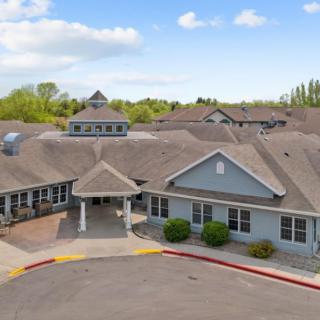 Aerial view of a residential building with a welcoming entrance and surrounding greenery.