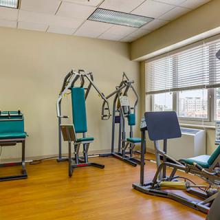 A small gym area with exercise machines and fitness equipment.