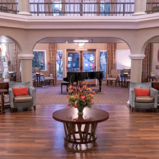 Elegant hotel lobby with a grand piano and comfortable seating.