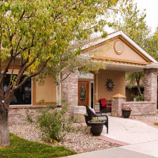 A suburban house with a front porch and landscaped yard.