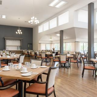 Modern dining area with neatly arranged tables and chairs.