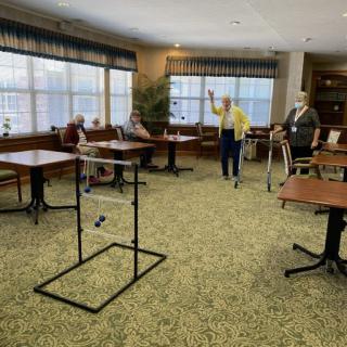 A group of seniors enjoying a game in a spacious indoor setting.