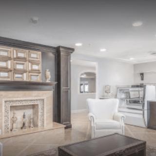 A modern living room with a stylish fireplace and comfortable seating.