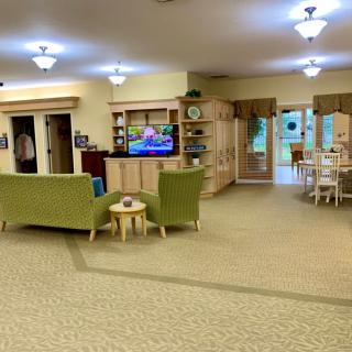 Spacious living room with seating area and entertainment center.