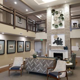 A welcoming lobby featuring comfortable seating, modern decor, and artwork that enhances the community atmosphere.