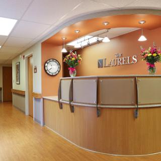 A welcoming healthcare reception area featuring a modern design and floral decorations.