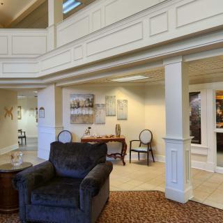 A well-lit hotel lobby with comfortable seating and elegant architectural details.