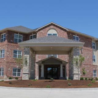 A modern multi-story residential building featuring a brick exterior and welcoming entrance.