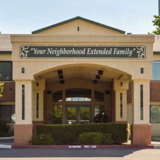 The front entrance of a building labeled 'Your Neighborhood Extended Family'.