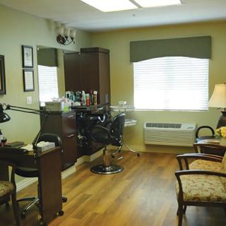 A cozy hair salon interior with styling chairs and equipment.