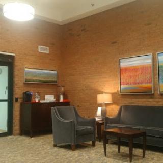 A cozy lobby area featuring comfortable seating and decorative artwork.