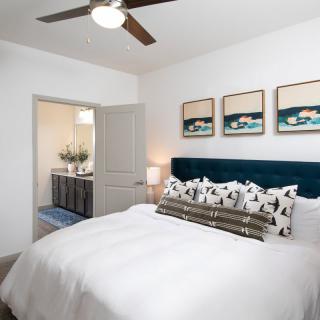 Modern bedroom with stylish decor and an adjoining bathroom.