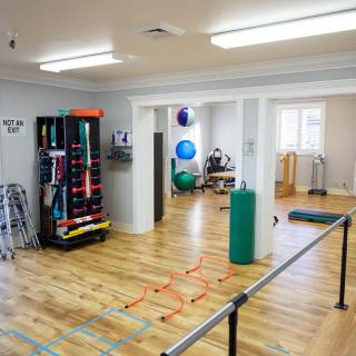 A well-equipped indoor gym with various exercise equipment and a spacious workout area.