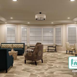 A modern living room with comfortable seating and large windows.