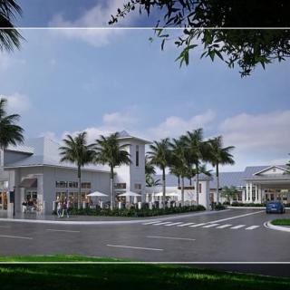 A modern architectural building surrounded by palm trees and a clear blue sky.