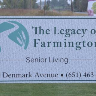 Sign for The Legacy of Farmington, a senior living community located on Denmark Avenue.
