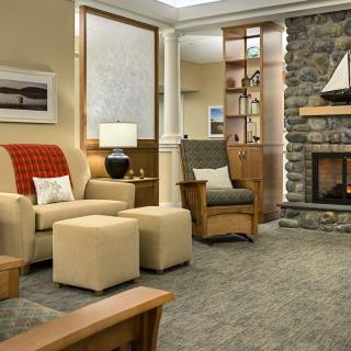 A cozy living room featuring a stone fireplace and comfortable seating.