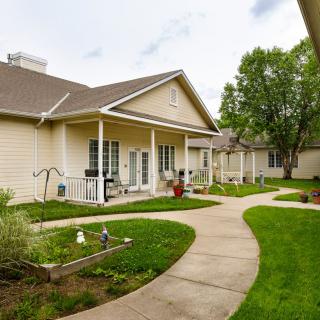 A view of a residential house with a well-maintained lawn and pathway.