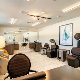 A modern hair salon interior with chairs, mirrors, and styling equipment.