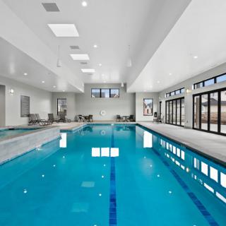 A spacious indoor swimming pool with a modern and sleek design.
