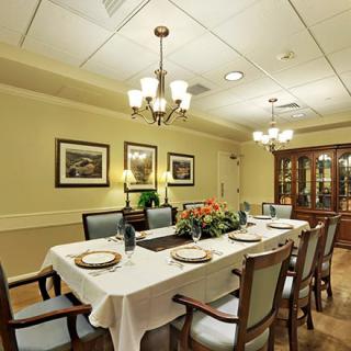 A beautifully set dining room with a long table and elegant decor.