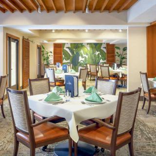 An elegantly set dining area with neatly arranged tables and chairs in a restaurant.