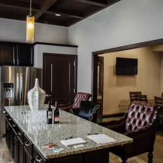 A modern kitchen with a granite island and luxurious seating.