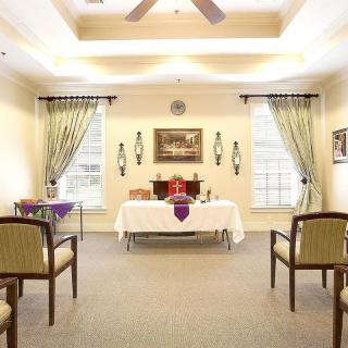 A peaceful chapel interior with an altar and arranged seating.