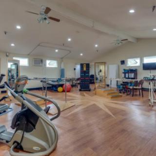A spacious gym equipped with various fitness machines and exercise equipment.