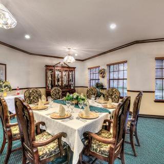 A well-decorated dining room with an elegant table setting and chandelier.