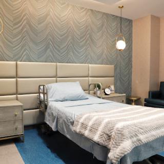 A modern and minimalist bedroom featuring a single bed and stylish decor.