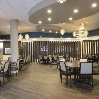 A modern restaurant dining area with elegant seating and ambient lighting.